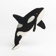 an orca whale stuffed animal on a white background