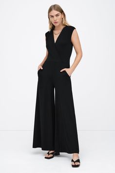 Our Davis Jumpsuit is effortlessly chic from head to toe. Her sleeveless top features slightly dropped shoulders and dips into an overlapped v-neckline, while her flowy wide-leg pants offer everybody's favorite utilitarian detail: pockets. From ultra-soft European jersey, Davis is a sleek fit that takes you from morning subway commutes to drinks after hours in style.[SPLIT] Maritza is 5'9" (177 cm) tall, wearing size XS. Approximately 56.5" (144 cm), measured from the shoulder to the bottom hem. Sustainable European Jersey (96% Tencel, 4% Elastane). Machine wash on delicate cycle, or hand wash in cold water. Tumble dry on low heat, or for best results, lay flat to dry. Designed in NYC. Handcrafted in Europe. Our production team enjoys a living wage, a 40-hour work week with paid overtime, Elegant V-neck Elastane Jumpsuits And Rompers, Versatile Fitted V-neck Jumpsuits And Rompers, Versatile Fitted V-neck Jumpsuit, Chic V-neck Elastane Jumpsuits And Rompers, V-neck Elastane Jumpsuit For Work, Versatile Black V-neck Jumpsuits And Rompers, Stretch Elastane V-neck Jumpsuits And Rompers, Elegant V-neck Elastane Jumpsuit Or Romper, Chic V-neck Stretch Jumpsuits And Rompers