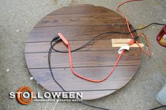 a wooden table with some wires attached to it