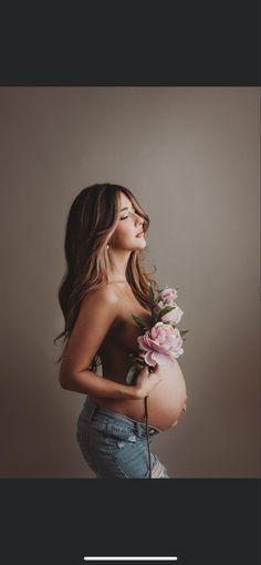 a pregnant woman holding flowers in her stomach with the caption, how do you get pregnant?