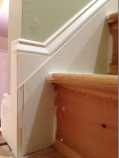 an unfinished stair case next to a white door in a house with pink walls and flooring