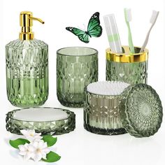 green glass bathroom accessories including toothbrushes and soap dispenser