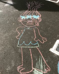 a child's drawing on the ground with chalk