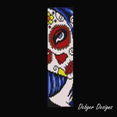 a cross stitch bookmark with an evil clown face on it