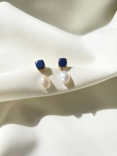 Two part dangler ~Lapis Lazuli stud with a freshwater pearl charm ~ Length : approx. 1.25" ~ Material: 18k gold plated brass 
 ~ Each pair of earrings comes in a velvet pouch in our signature box, perfect for gifting. Blue Pearl Charm Earrings As Gift, Classic Blue Pearl Earrings For Gift, Velvet Pouch, Pearl Charms, Lapis Lazuli, Fresh Water, Freshwater Pearls, 18k Gold, Gold Plate