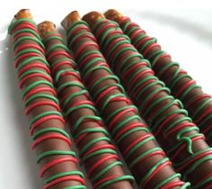 several chocolate covered candys with green and red stripes