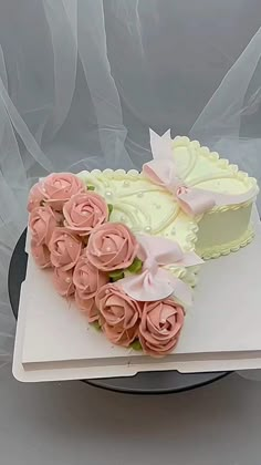 a heart shaped cake decorated with pink roses