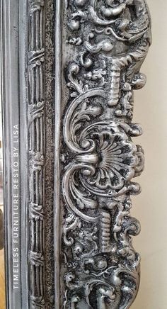 an ornate metal frame with carvings on it