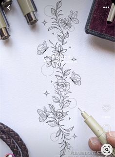 someone is drawing flowers on the paper