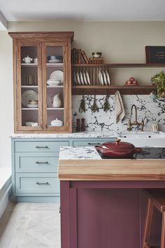 a kitchen with marble counter tops and wooden cabinets