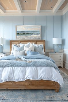 a bedroom with blue walls and white bedding