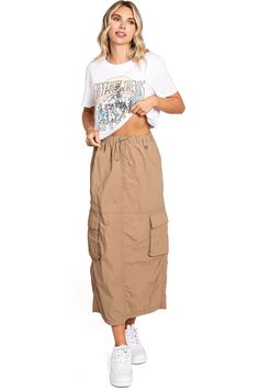 Chic, parachute skirt with an elastic waistband, a drawstring cinch tie and cargo pockets down the sides. Pair it with a graphic tee and sneakers for an effortless streetwear look. CARE | Machine Wash Cold CONTENTS | 100% Nylon MEASUREMENTS | 33"/85 cm Top to Bottom (Size Small) MODEL | 5'8 - wearing a size Small IMPORTED Casual Parachute Pants With Functional Drawstring For Spring, Summer Utility Parachute Pants With Drawstring, Urban Style Summer Parachute Pants With Elastic Waistband, Urban Parachute Pants With Elastic Waistband For Summer, Casual Drawstring Cargo Skirt For Summer, Casual Cargo Skirt With Drawstring For Summer, Utility Style Parachute Pants For Summer Streetwear, Casual Summer Cargo Skirt With Drawstring, Summer Utility Parachute Pants For Streetwear