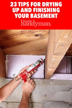 a man is painting the bottom of a wall with white paint and red lettering that reads 23 tips for drying up and finishing your basement