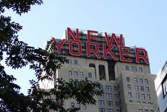 a large sign on top of a building that says new yorker in red letters