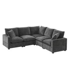 a gray sectional couch with pillows on it's back and the seat facing outward