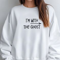 Embrace the spooky season with this playful and cozy "I'm with the Ghost" sweatshirt! Featuring a fun graphic design, this sweatshirt is perfect for Halloween or any day you feel like adding a bit of ghostly charm to your outfit. Made with soft, comfortable fabric, it's ideal for layering or wearing on its own. Get ready to haunt in style! Washing: Machine wash in cold water. Use a mild detergent. Wash with similar colors. Turn the sweatshirt inside out to protect the design (if any). Drying: Tu White Crew Neck Sweater For Halloween, Oversized White Halloween Sweater, Casual White Sweatshirt For Halloween, Casual White Sweater For Halloween, Spooky Letter Print Sweatshirt For Winter, Fun Graphic Design, Spooky Sweatshirt, Ghost Sweatshirt, Halloween Crewneck