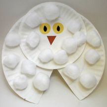 a paper plate with an owl face made out of white foam and yellow eyes on it