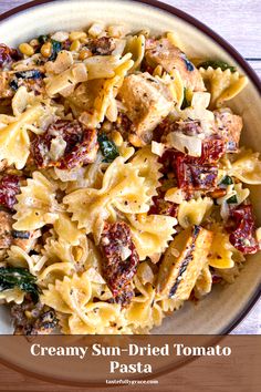 a bowl filled with pasta and meat on top of a wooden table