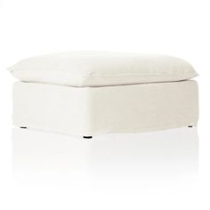 a white ottoman that is sitting on top of a floor with the cover pulled down