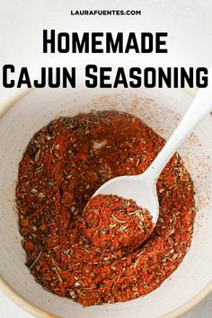 homemade cajun seasoning in a white bowl with a spoon and title overlay