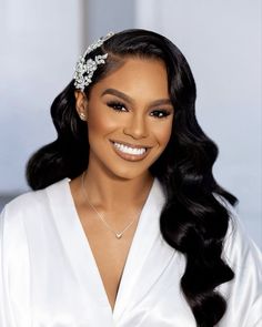 a woman with long black hair wearing a white dress and a tiara on her head