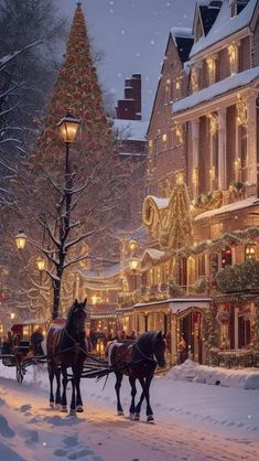 two horses pulling a sleigh down a snowy street with christmas lights on it