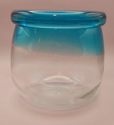 a blue glass vase sitting on top of a table