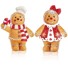 two gingerbread men are holding candy canes