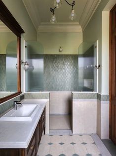 a large bathroom with two sinks and mirrors