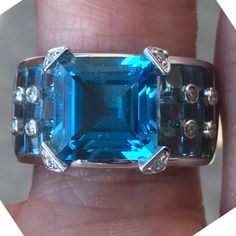 M4300-02 Center Stone Details : Stone: Topaz Carat Weight: 9.0 Apprx Shape: Emerald Shape Color: Blue Clarity : Eye Clean Setting Details: Finger Size: 7( Can Be Sized) Metal: 10k White Shape Of Topaz: Princess Carat Weight: 2 Carat Apprx Diamond : 12 Round We Are Not Affiliated In Anyway With Any Of The Following Brands - Tiffany & Company , Cartier , Herms , Chanel , Rolex , Graff , Harry Winston , Louis Vuitton , Goyard Designer Blue Jewelry For Anniversary, Emerald Blue, Mercedes Maybach, Harry Winston, 2 Carat, Womens Jewelry Rings, Blue Topaz, Topaz, Dream Wedding