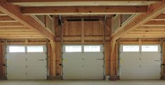 an empty garage with two large doors and no one in the room or on the floor