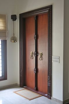 a large wooden door sitting inside of a room