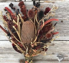 an arrangement of dried flowers in a vase