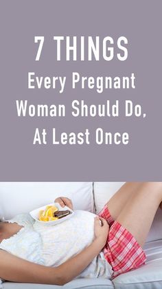 a woman laying on top of a white couch holding a tray with food in it