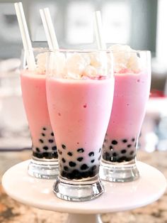 three glasses filled with different types of drinks