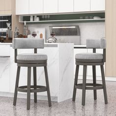 two gray bar stools sitting in front of a white counter top with an oven