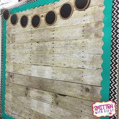 a wooden wall with circles on it and black and white chevron border around the edges