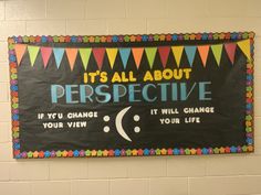 a bulletin board hanging on the wall in a school hallway that says it's all about perspective