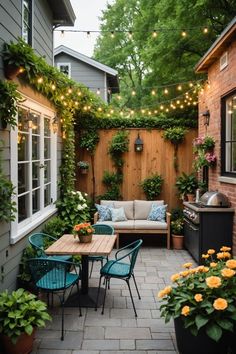 an outdoor patio is decorated with lights and potted plants