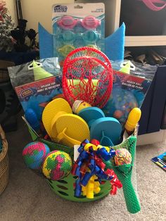 a basket filled with lots of toys on the floor