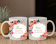 two personalized coffee mugs sitting on top of a table next to a potted plant