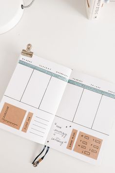 an open planner sitting on top of a desk