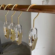 three glass keys are hanging from a coat rack