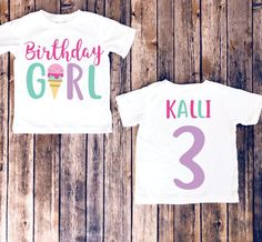 two birthday shirts with the number three and an ice cream cone on them, sitting against a wooden background