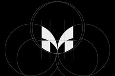 three circles with the letter m on them in white and black, against a black background