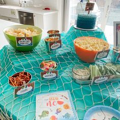 a table topped with lots of food on top of a blue cloth