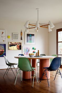 a dining room table with four chairs around it