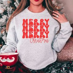 Listing: (1) Merry Merry Merry Christmas Retro Sweatshirt - Celebrate the reason for the Christmas season in this soft and cozy crew neck fleece pullover. Main Listing Photo: Ash sweatshirt with red lettering. 2nd Listing Photo: Red sweatshirt with white lettering. 3rd Listing Photo: White sweatshirt with red lettering. See more holiday items here: https://www.etsy.com/shop/tcctn?section_id=27290931 Branding: Adult: Gildan / Unisex sizing *Size chart available in the photos section -Care Instruc Red New Year Sweatshirt Women, Christmas Retro, Retro Sweatshirts, White Fleece, Retro Christmas, White Sweatshirt, Winter Holidays, Cotton Tops, Sweatshirts Women