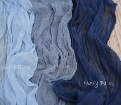 four different colors of sheer fabric on a wooden surface with the words light blue dusty blue