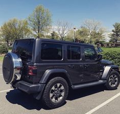 a black jeep parked in a parking lot